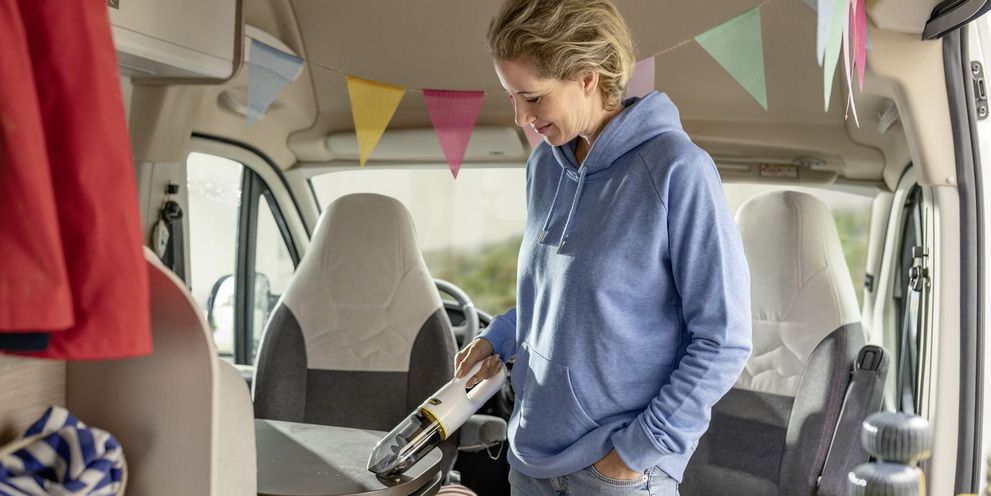 Cleaning caravan interior with vacuum cleaner