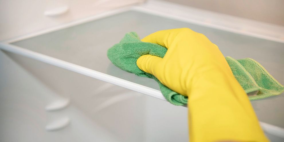 The interior of the fridge is cleaned with a cloth
