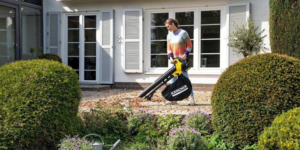 Clearing leaves with a blower vac Clearing leaves with a Kärcher blower vac