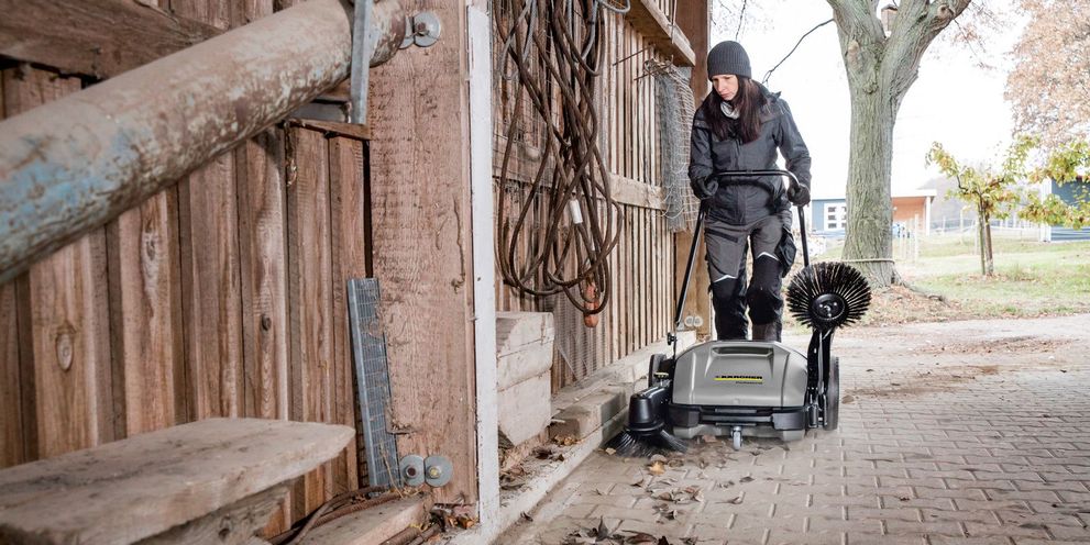 Cleaning of the outdoor area with a push sweeper Cleaning of the outdoor area with a push sweeper