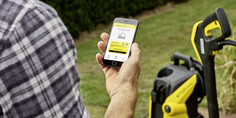 Man with Home & Garden app on mobile phone