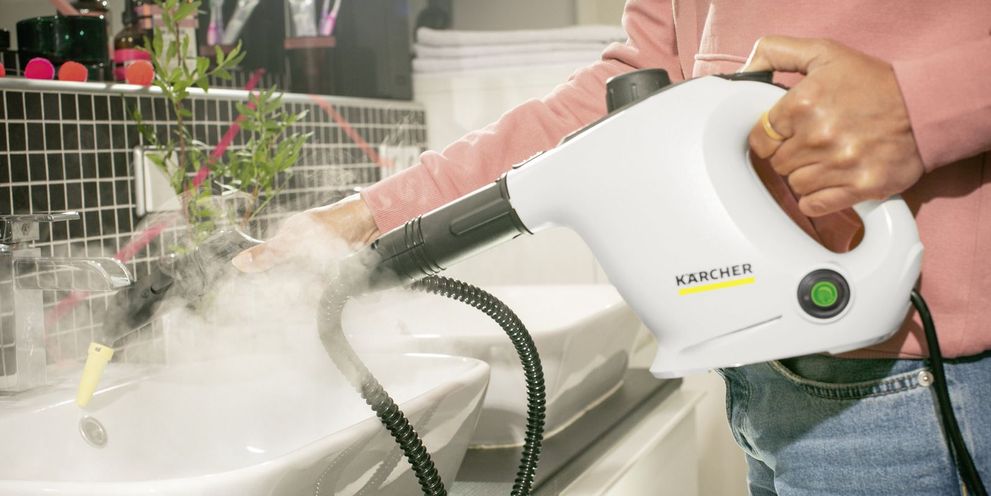 Steam cleaning the washbasin with a Kärcher steam cleaner