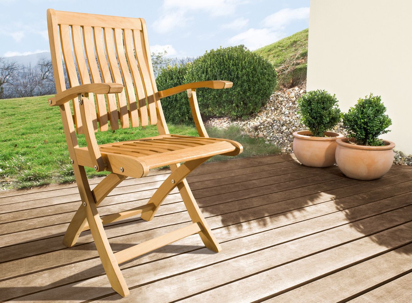Cleaning wooden garden furniture A brown wooden garden chair on a patio