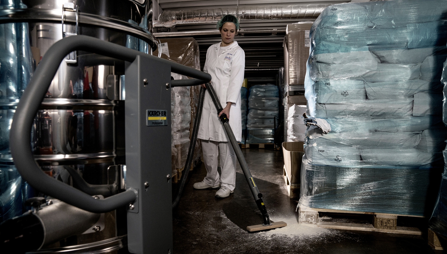 A woman vacuums the food storage area