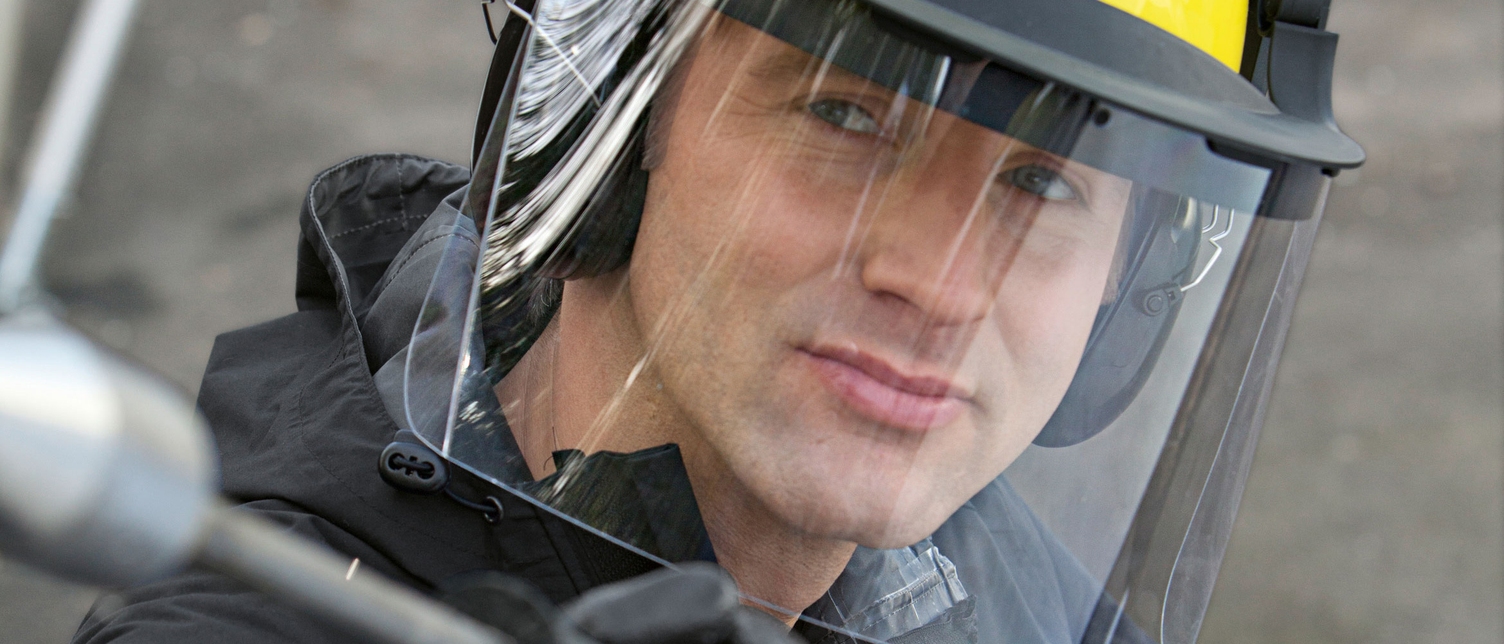 Person wearing a safety helmet with a visor Person wearing a safety helmet with a visor