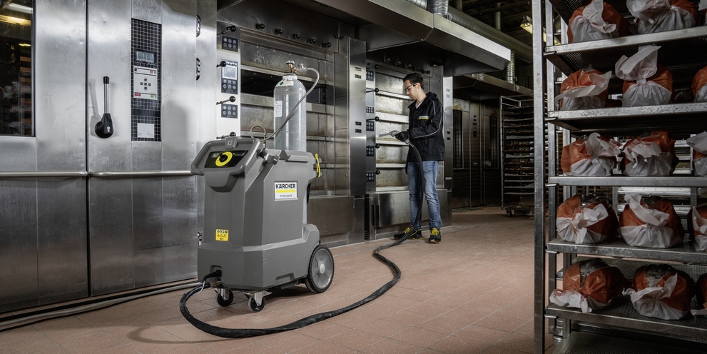  A person gently cleans surfaces with the dry ice blasting machine