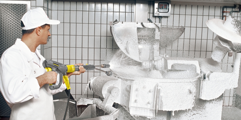 A person cleans the production facility with the high-pressure cleaner