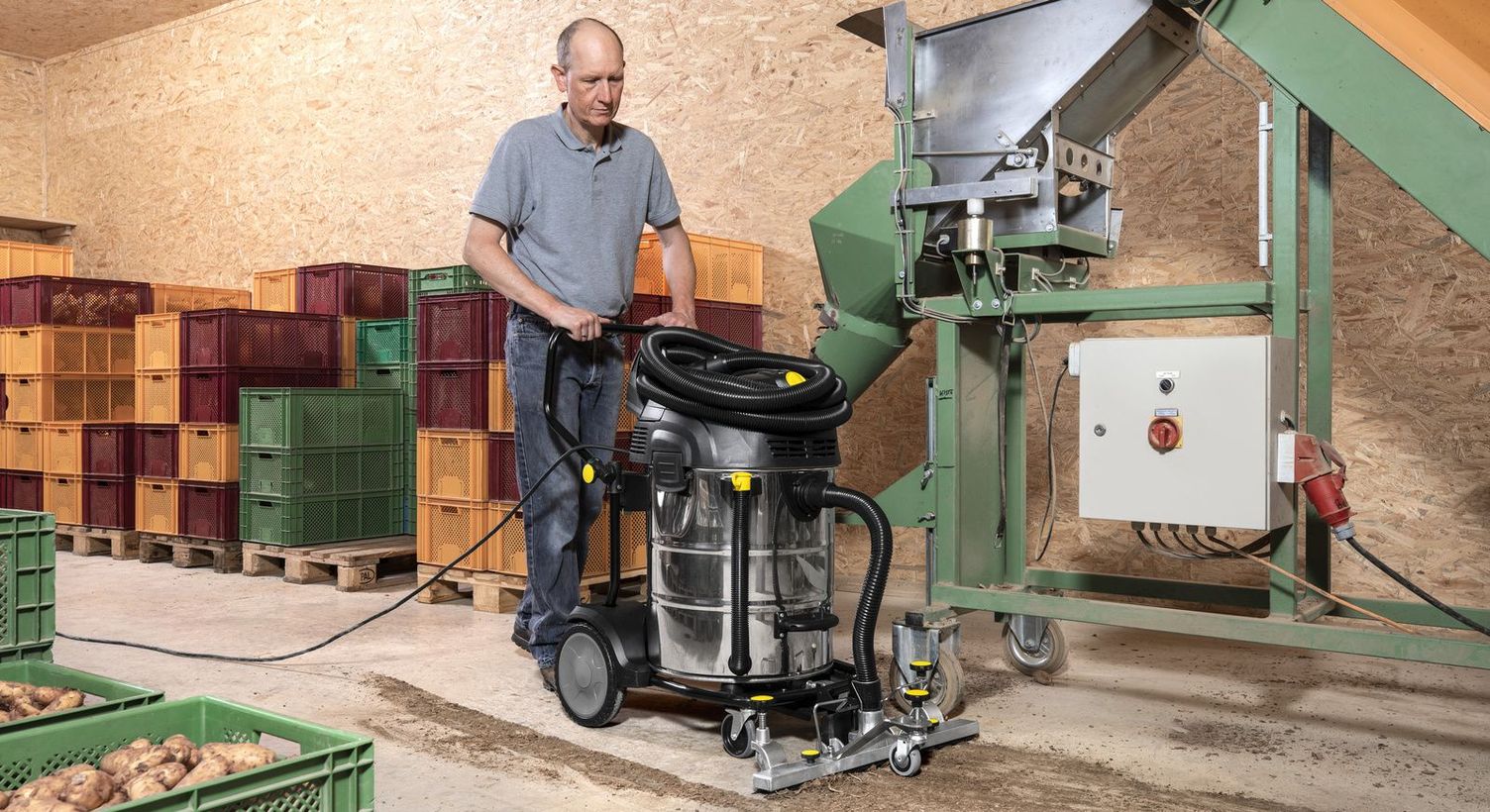 Floor cleaning in the farm warehouse with a wet/dry vacuum cleaner