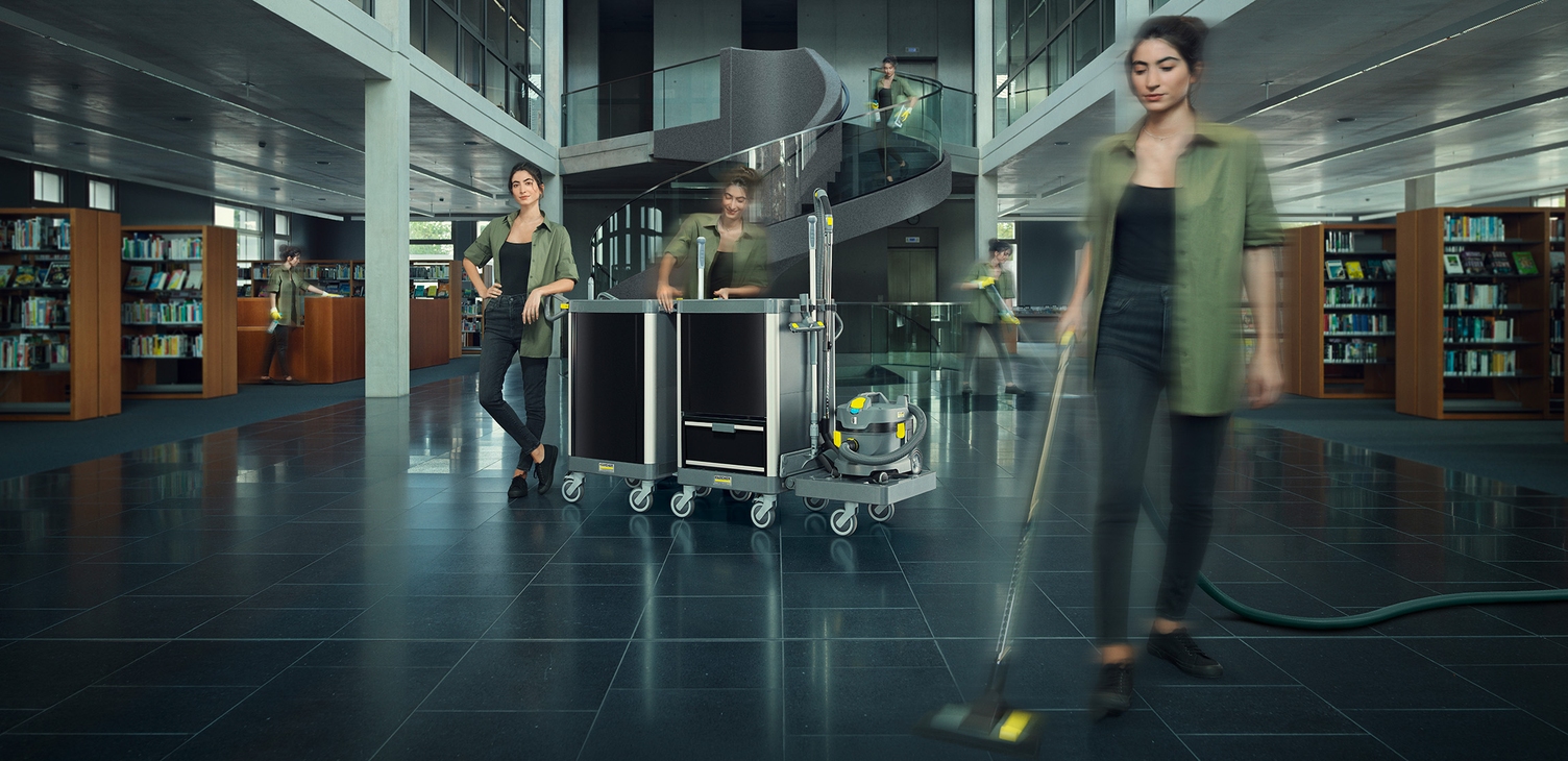 Person cleaning a foyer with the Kärcher manual cleaning equipment