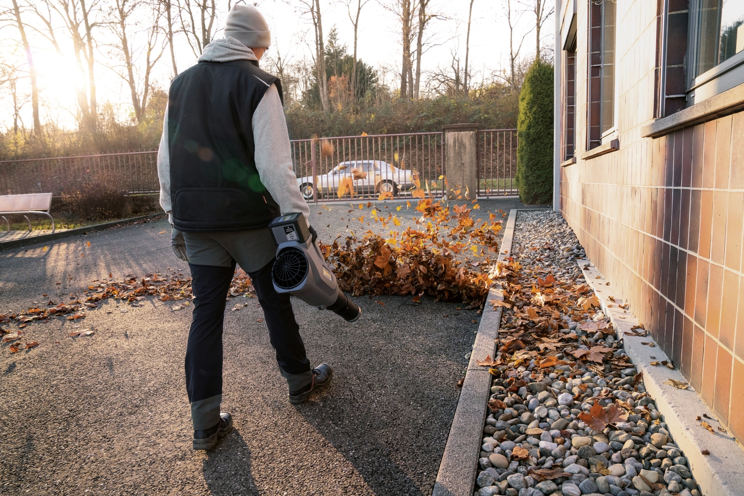 A person operating a leaf blower