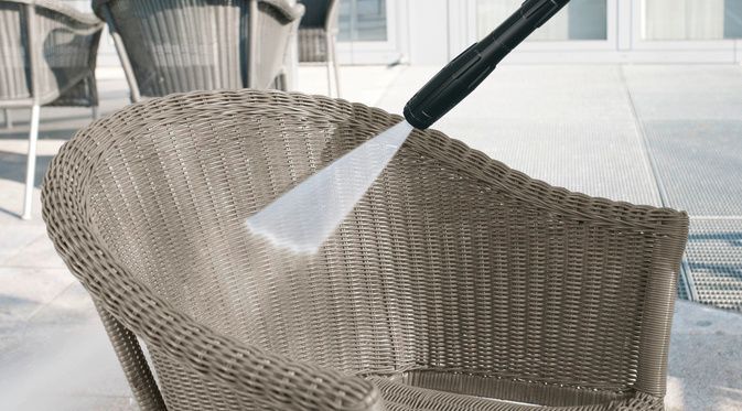 A rattan chair being cleaned with foam