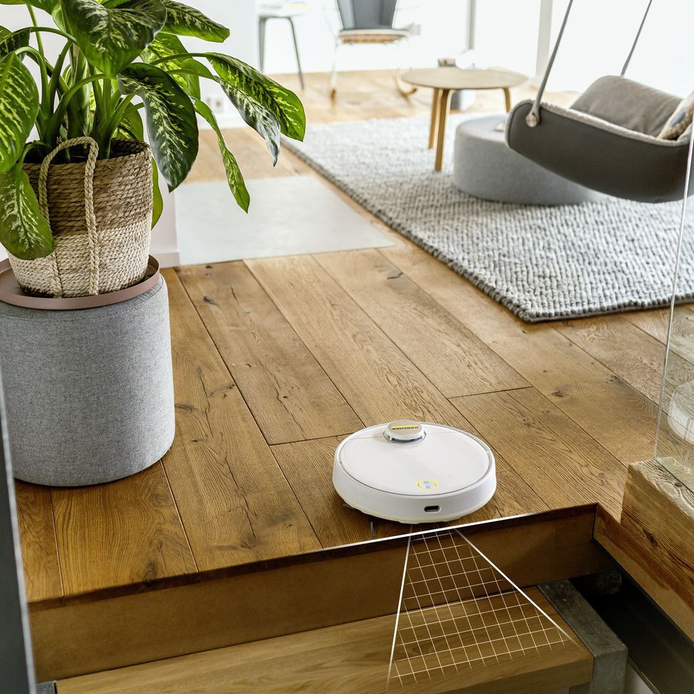 Robot vacuuming and mopping in front of stairs