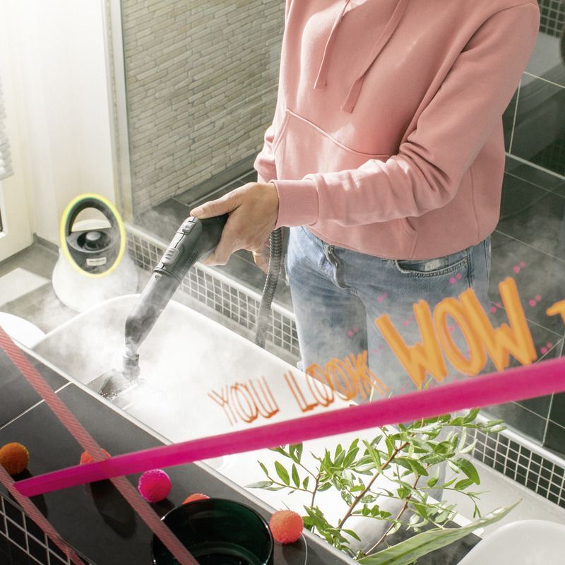 Woman cleaning bathroom using Kärcher steam cleaner SC 2 Deluxe EasyFix