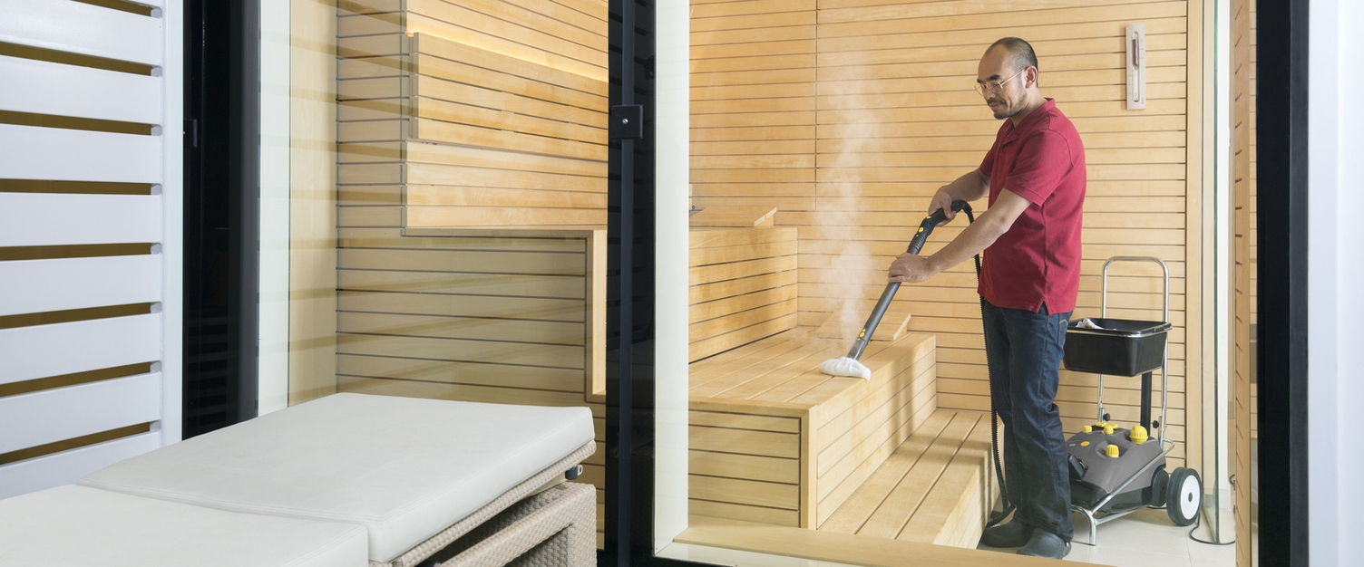 A person operating a steam cleaner