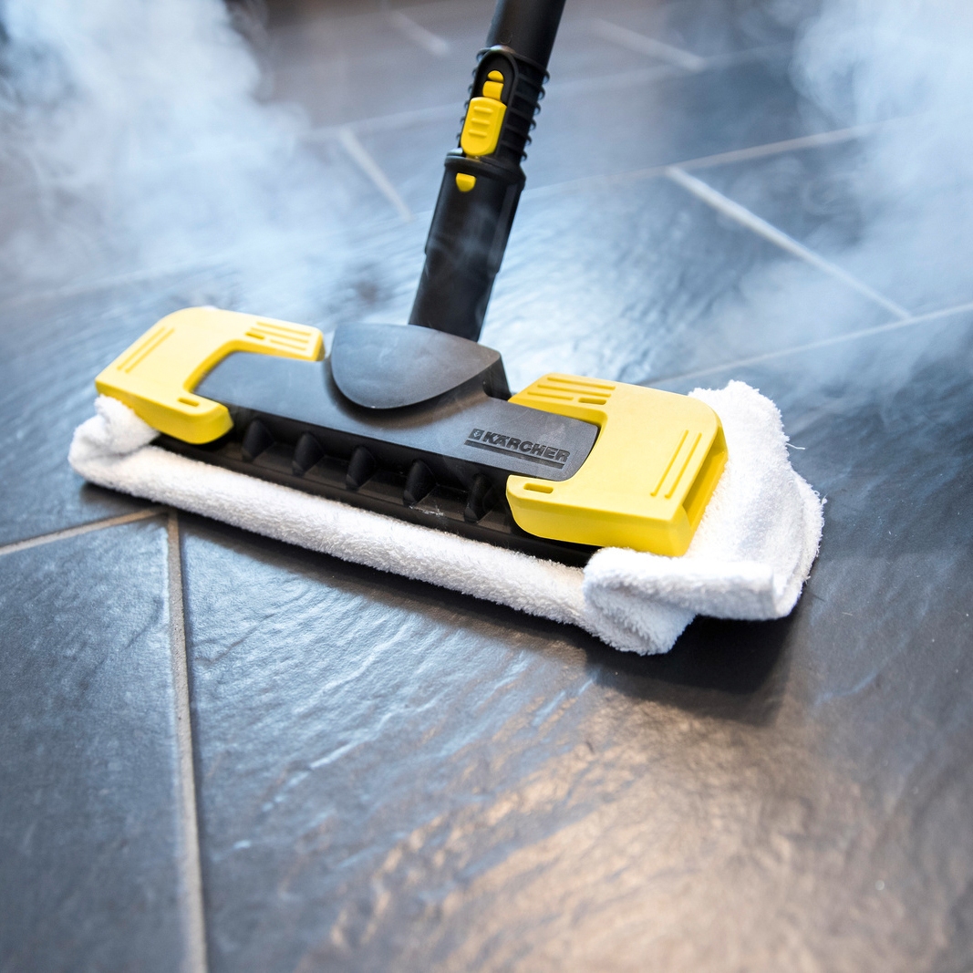 Cleaning the fllor with a steam cleaner