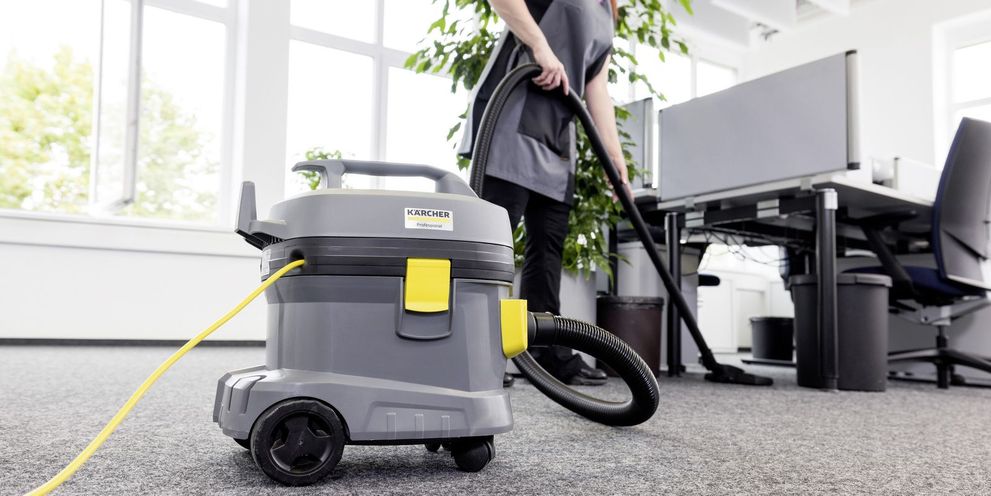 A person cleans the floor of an office
