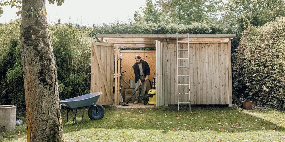 Man is removing moss with a Kärcher pressure washer