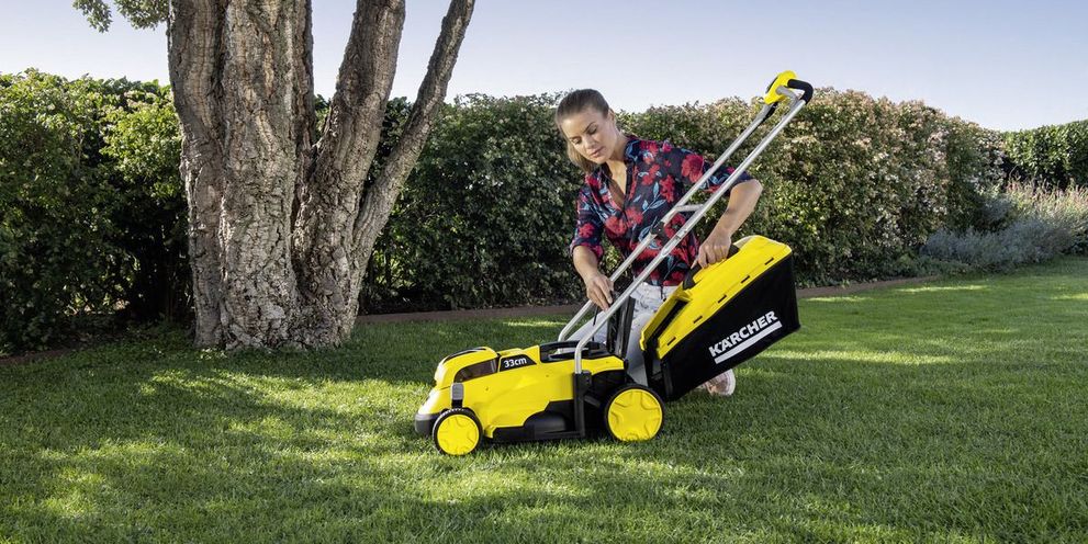 Woman preparing her Kärcher lawn mower