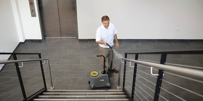 Person cleaning a stair railing
