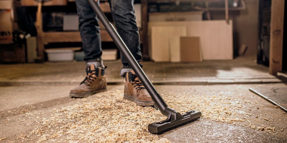 Sawdust is vacuumed up in the workshop with a wet and dry vacuum cleaner