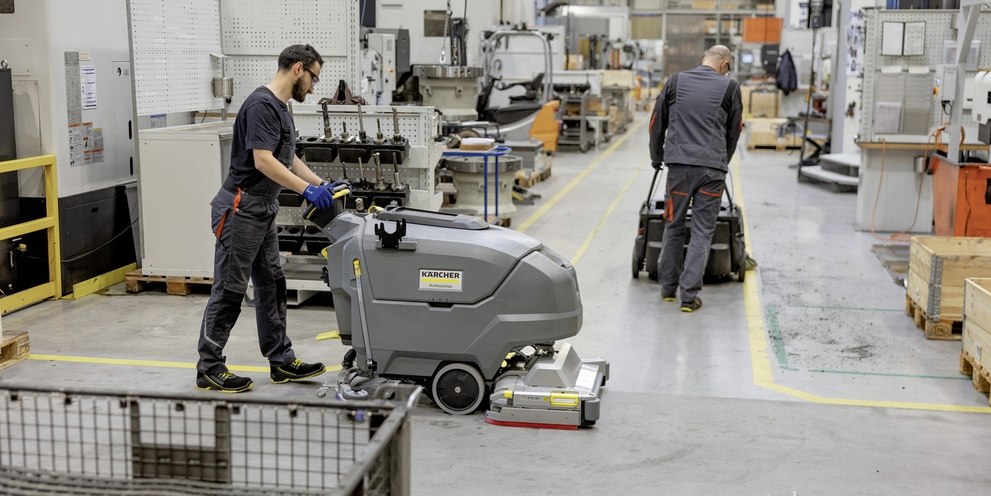 Walk behind scrubber dryer is cleaning floor Walk behind scrubber dryer is cleaning floor