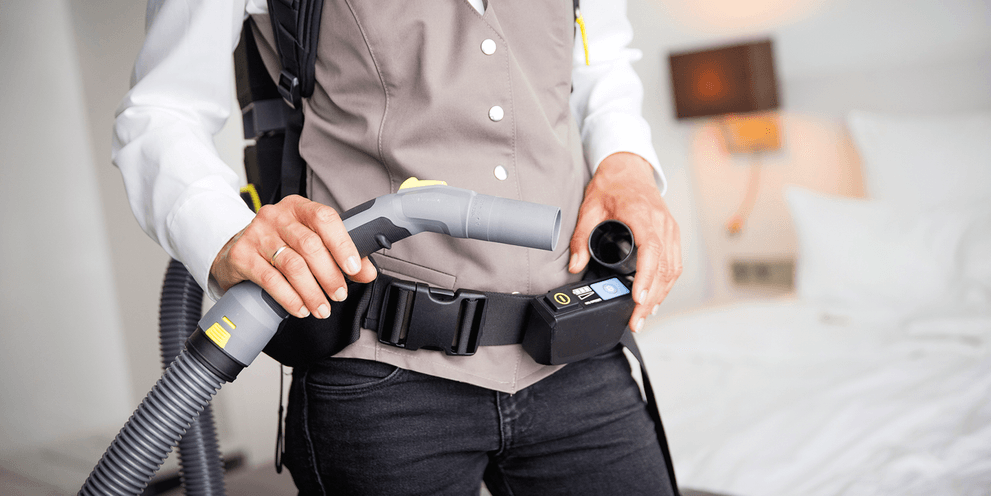 Person is using the hip belt of the backpack dry vacuum cleaner Person is using the hip belt of the backpack dry vacuum cleaner