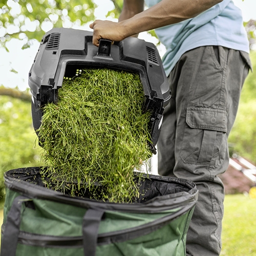 Emptying the grass collector bag after mowing