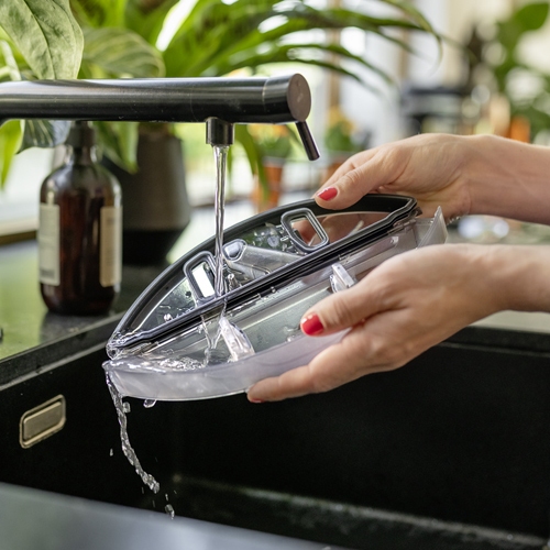 Cleanign the dirty water tank of the robot vacuum mop with tap water