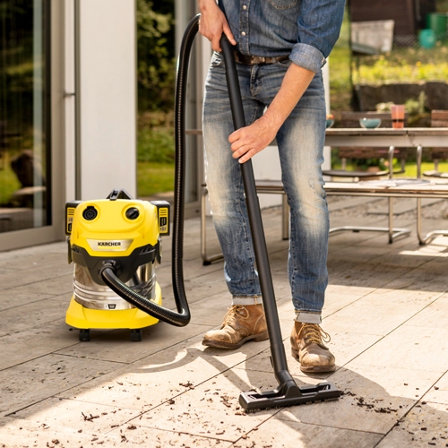 Vacuuming a patio with the wet and dry vacuum cleaner floor nozzle