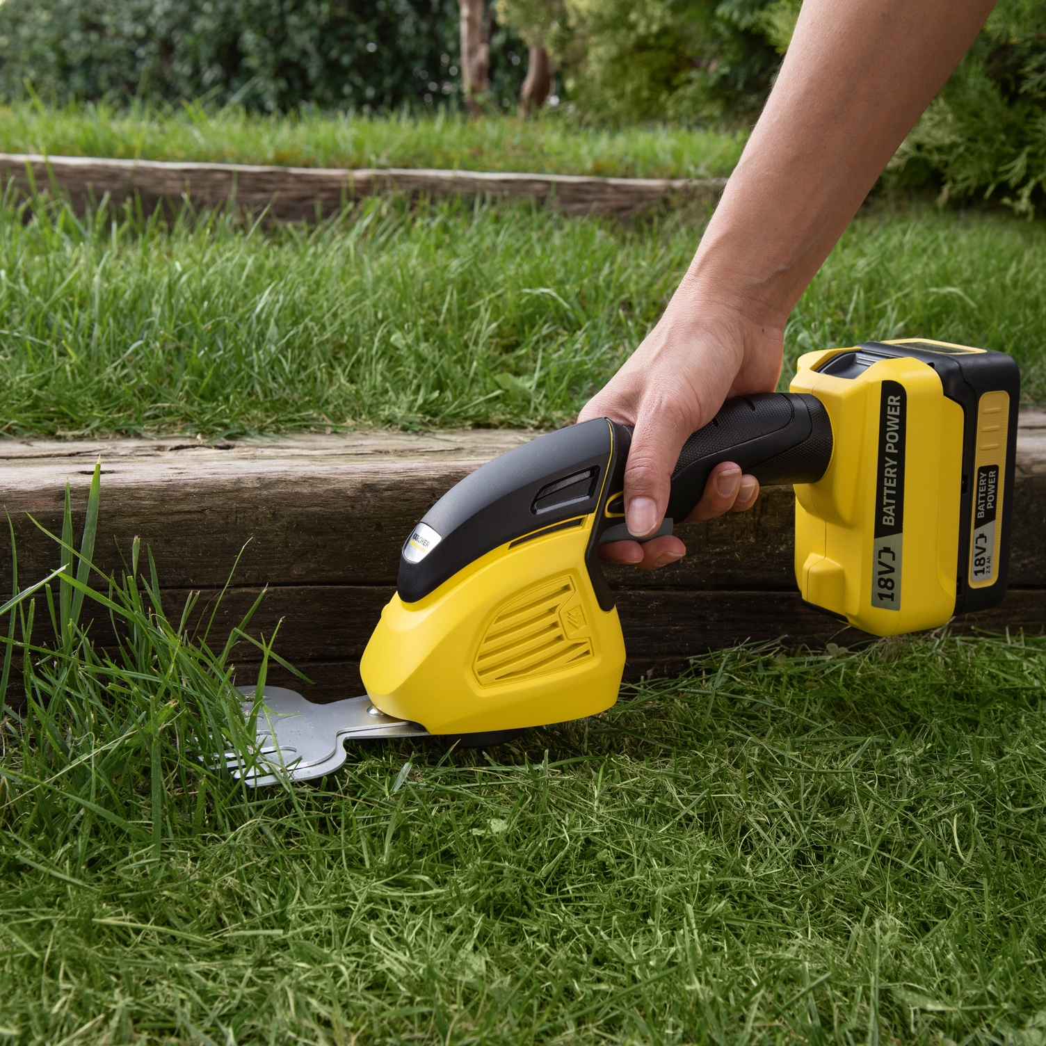 Cutting grass with the grass and shrub shear with rubber handle