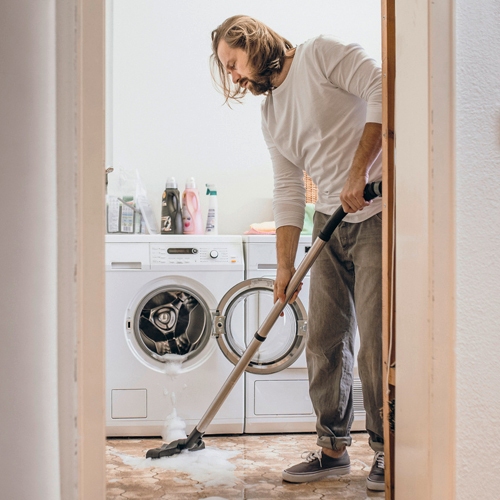 Cleaning the floor with wet and dry vacuum cleaner with floor nozzle