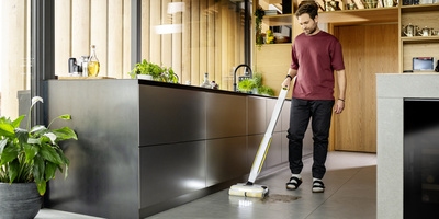 Person cleaning floor with Kärcher Floor Cleaner