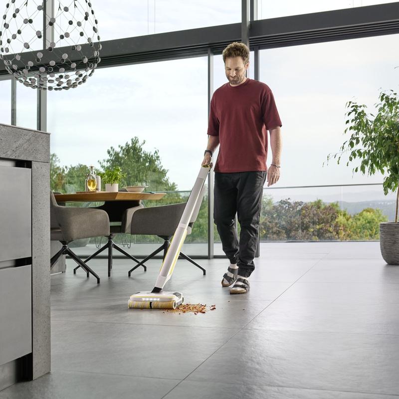 Person cleaning the floor with a Kärcher Floor Cleaner