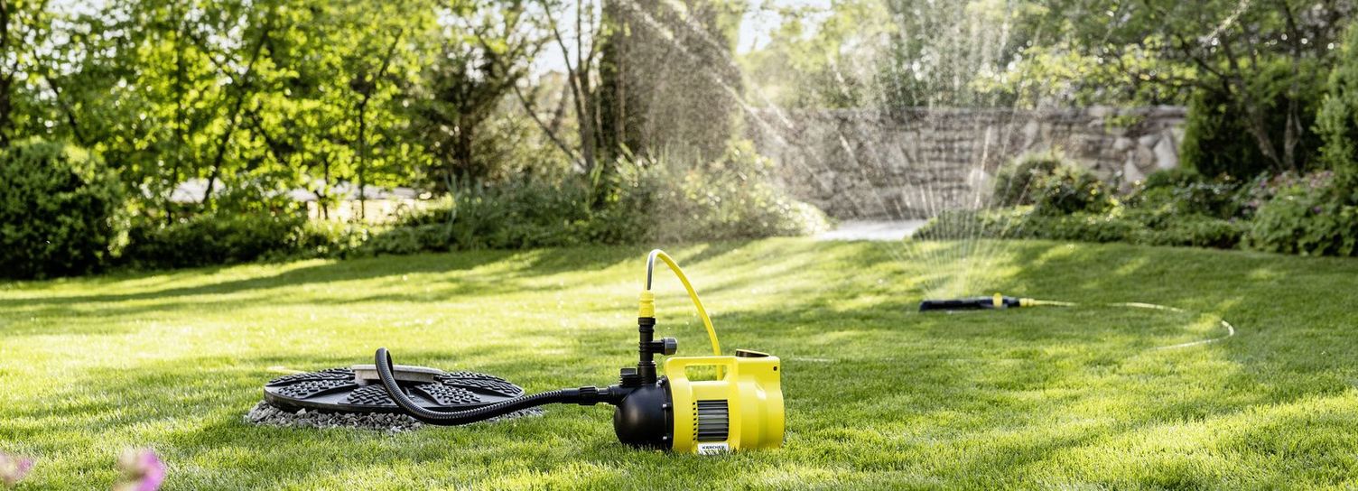 Watering the garden with a Kärcher pump and sprinkler