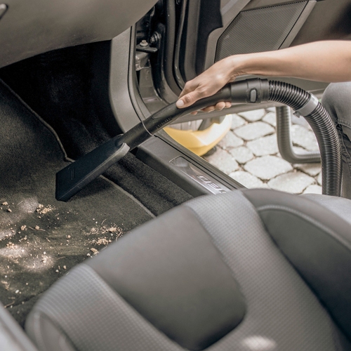 Vacuuming car interiour with ergonomic handle