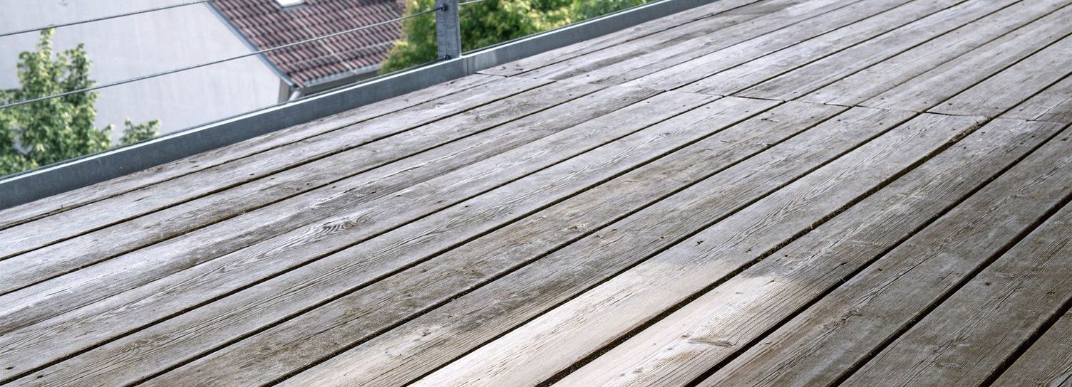 A wooden deck with light and dark grey tones