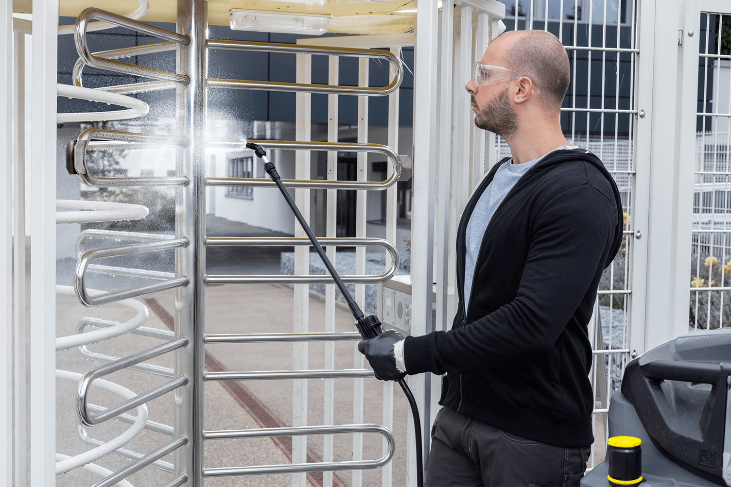 Scrubber dryer attachment kit for disinfecting surfaces using a spray. Man seen using scrubber dryer attachment kit for disinfecting surfaces using a spray.