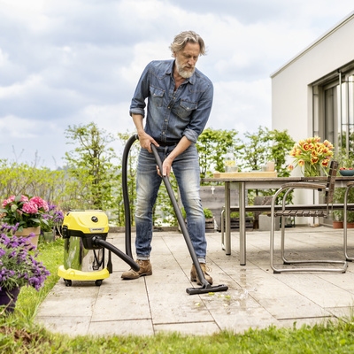 Vacuuming up water from a patio with the wet and dry vacuum cleaner