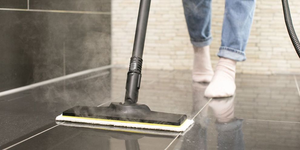Cleaning the floor with steam