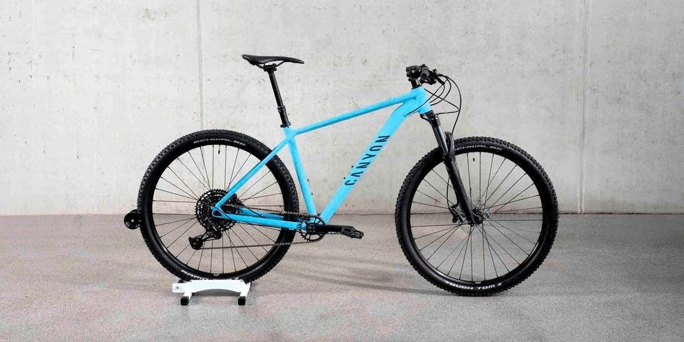 A light blue bike on a stand