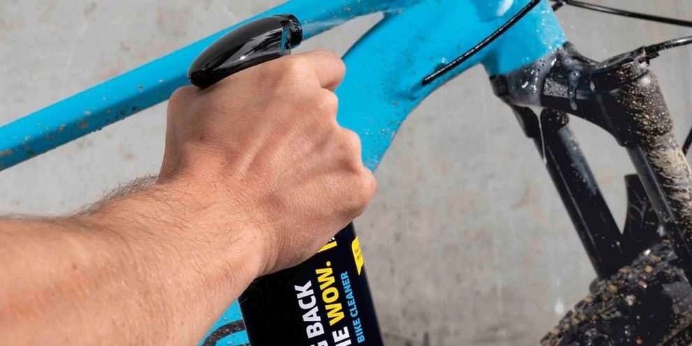 A light blue bicycle is sprayed with Kärcher two-wheel cleaner