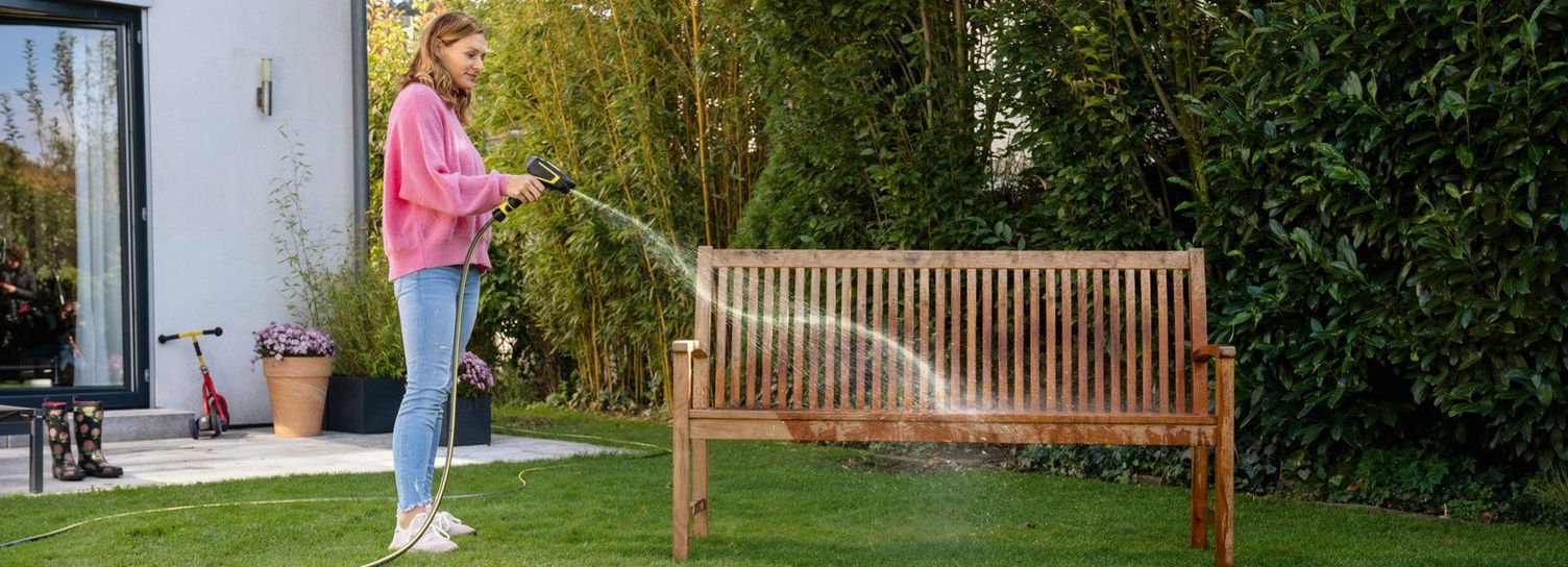 Cleaning garden bench with a cleaning sprayer Garden bench is cleaned with Kärcher cleaning sprayer