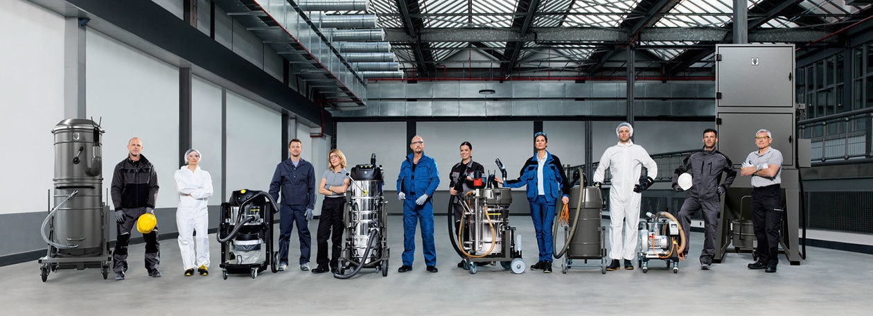 Kärcher Industrial Vacuum Cleaners People posing among multiple Kärcher industrial vacuum cleaners.