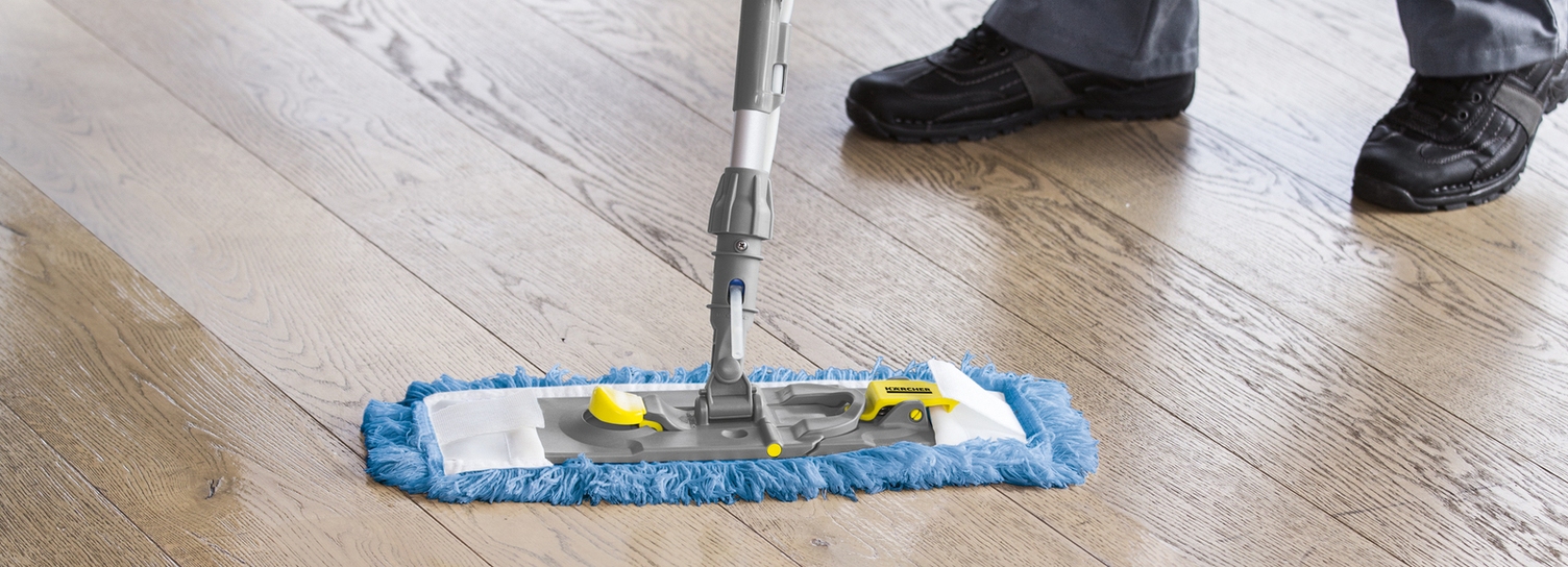 A person mopping a wooden floor