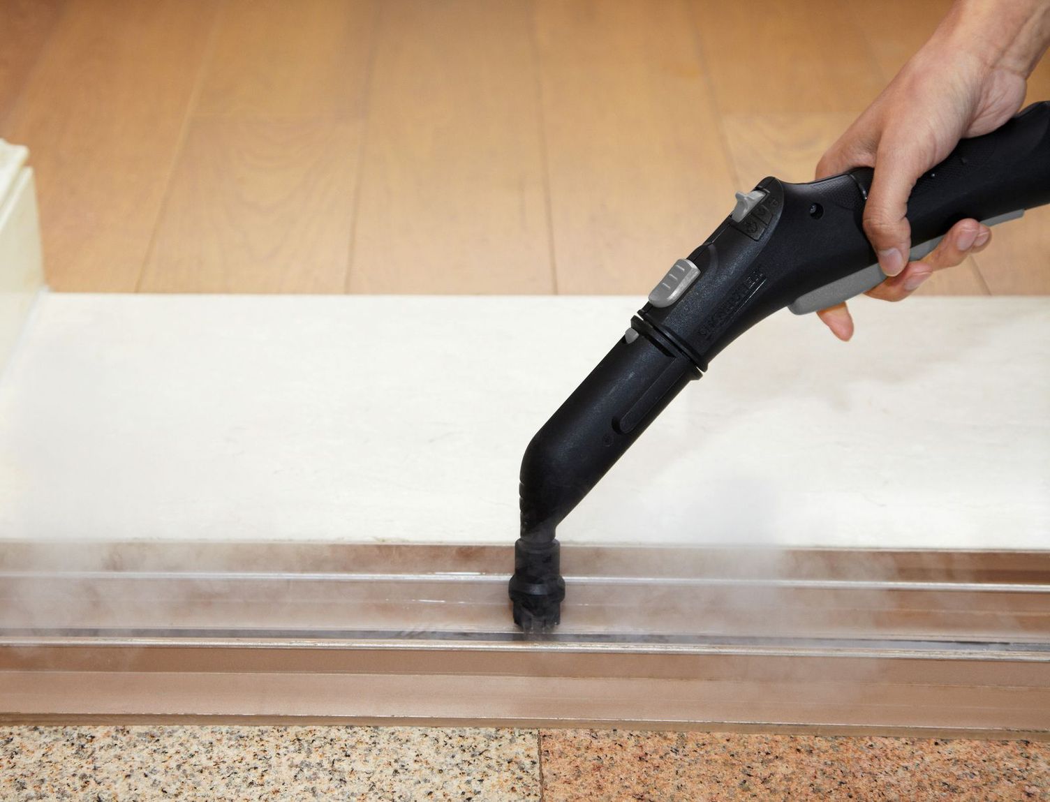 A closeup view of a steam cleaner disinfecting hotel rooms.