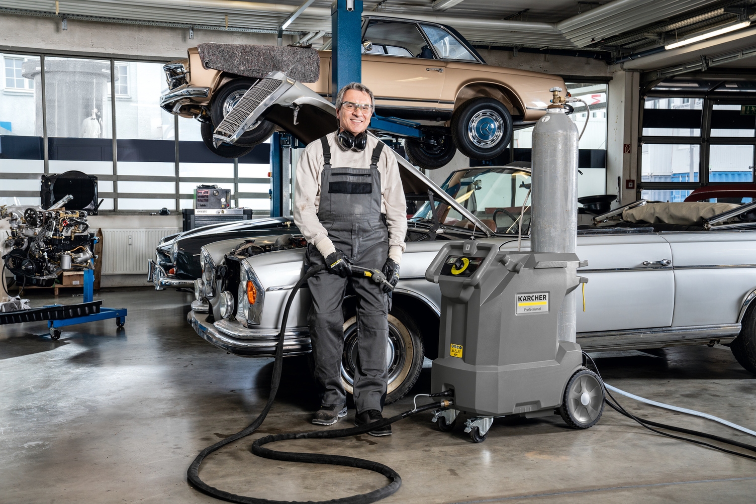So versatile. So complete. A man stands net to the IB 10/8 L2P Dry Ice Blaster in an autoshop.
