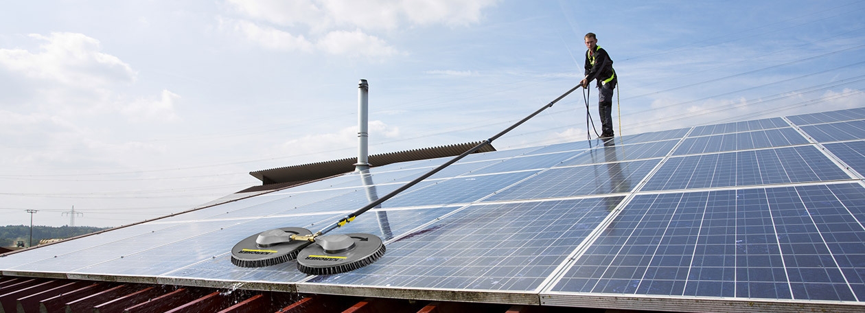 iSolar Solar Panel Cleaner A worker cleans solar panels using iSolar.