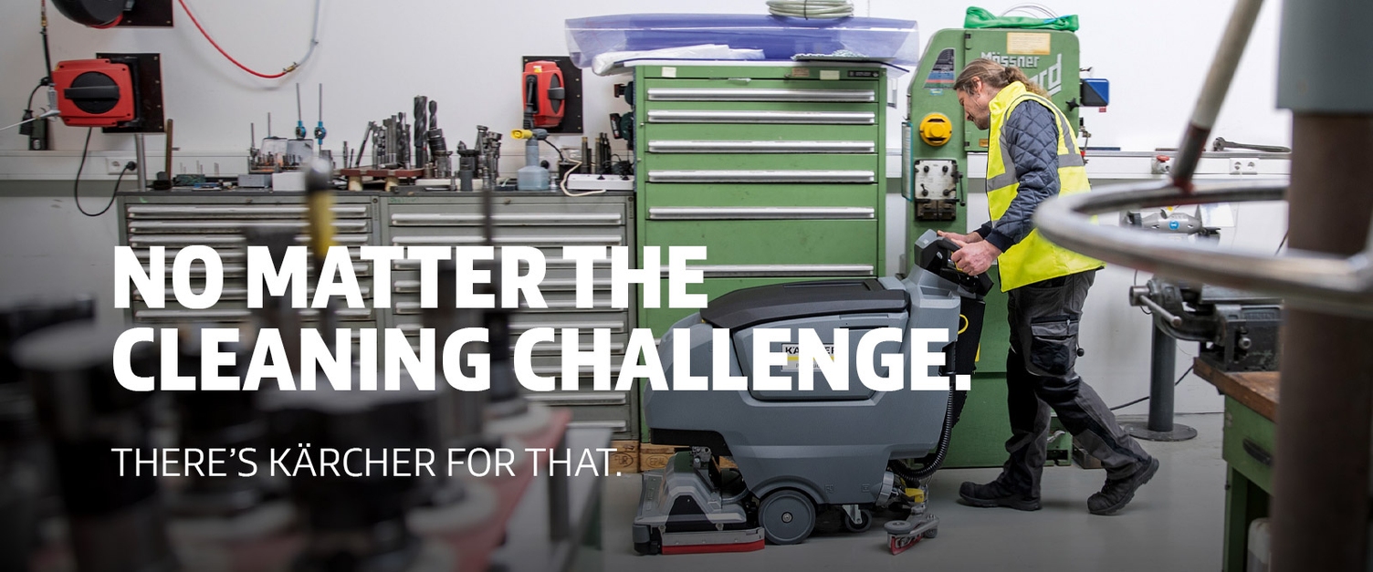 A man cleans a shop with Kärcher's B 50 walk-behind floor scrubber.