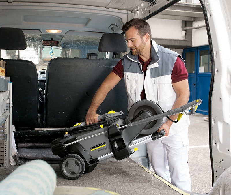 Improve Productivity by Renting a Pressure Washer A man loads a rented pressure washer into a van.