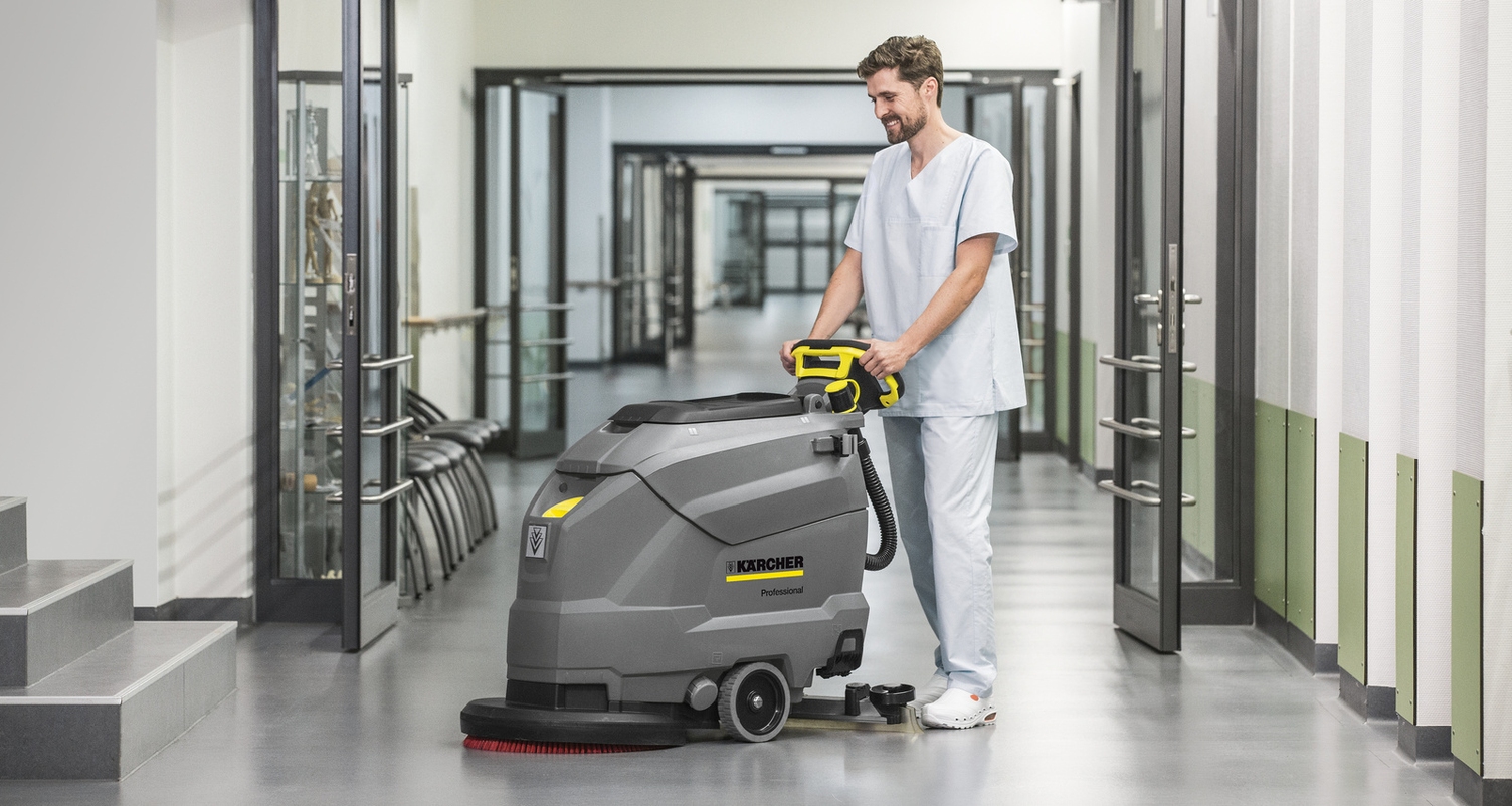 Prerequisite No. 2: Process Quality A worker cleans hospital hallway floors with a walk-behind floor scrubber.